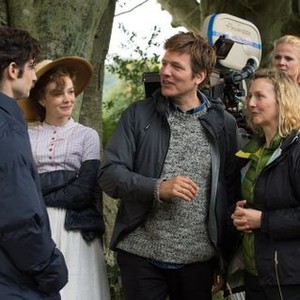 FAR FROM THE MADDING CROWD, Carey Mulligan (bonnet), director Thomas Vinterberg (sweater), cinematographer Charlotte Bruus Christensen (clasped hands), on set, 2015. ph: Alex Bailey/TM & copyright © Fox Searchlight. All rights reserved
