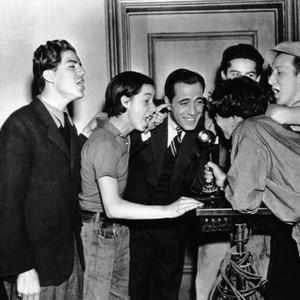CRIME SCHOOL, Humphrey Bogart, center, tries to talk on the phone while costars (from left) Billy Halop, Bobby Jordan, Gabriel Dell, Bernard Punsly, Huntz Hall, interrupt, 1938