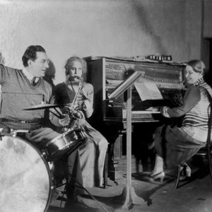 METROPOLIS, director Fritz Lang (drums), Brigitte Helm (saxophone) having fun on set, 1927