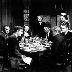 THE STRANGER, seated clockwise from center: Loretta Young, Orson Welles, Byron Keith, Philip Merivale, Richard Long, Edward G. Robinson, Isabel O'Madigan (standing center), Martha Wentworth (standing right), 1946