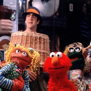 Elmo (center) encounters characters like the villainous Huxley (Mandy Patinkin, background) when he goes on an adventure into a far-away land to find his cherished blue blanket.