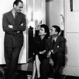 THEY ALL KISSED THE BRIDE, from left, Melvyn Douglas, Joan Crawford, director Alexander Hall, outside Crawford's dressing room, 1942