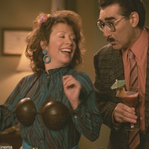 Ms. Heller (Cheri Oteri) and Principal Collins (Eugene Levy) celebrate their scam in New Line Cinema's upcoming comedy, Dumb and Dumberer: When Harry Met Lloyd.