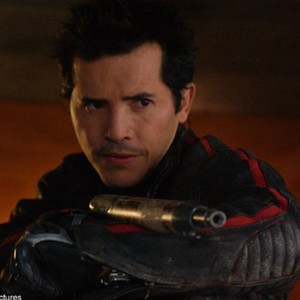 JOHN LEGUIZAMO stars as Cholo, one of a group of mercenaries hired to keep the city of the living in supplies.