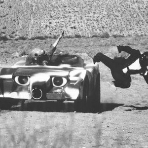 DEATH RACE 2000, Mary Woronov, (as Calamity Jane), tosses a rebel assassin from her car, 1975.