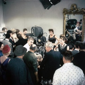 BREAKFAST AT TIFFANY'S, DIRECTOR BLAKE EDWARDS (LEFT, WHITE SHIRT), AUDREY HEPBURN (BACK RIGHT), ON SET, 1961