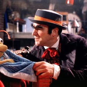 The villainous Huxley (Mandy Patinkin, right) and his partner in crime Bug the bug succeed in swiping Elmo's fuzzy blue blanket.
