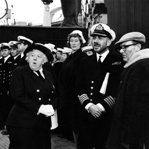 MURDER AHOY!, third, fourth , eighth, tenth and eleventh from left: Derek Nimmo, Margaret Rutherford, Joan Benham, Lionel Jeffries with director George Pollock on location, 1964