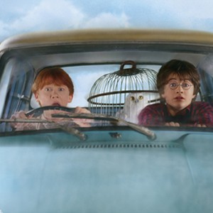 (L-r) Ron (RUPERT GRINT), Hedwig and Harry (DANIEL RADCLIFFE) in the flying Ford Anglia in Warner Bros. Pictures' "Harry Potter and the Chamber of Secrets."