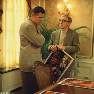 Studio head Hal Yeager (TREAT WILLIAMS) shows director Val Waxman (WOODY ALLEN) some poster ideas for his latest picture in Woody Allen's contemporary comedy HOLLYWOOD ENDING.