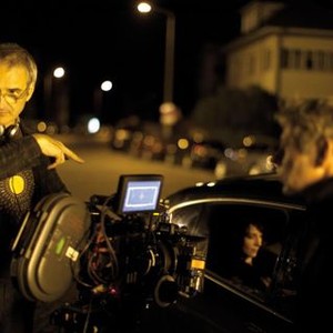 CLOUDS OF SILS MARIA, director Olivier Assayas (left), Juliette Binoche (in car), on set, 2014. ph: Carole Bethuel/©IFC Films