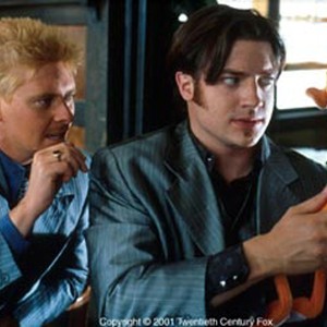 Herb (DAVE FOLEY, left) and Stu (BRENDAN FRASER) examine Monkeybone. a cartoon creation that has come to life.