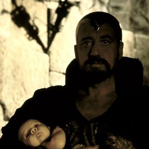 EXCALIBUR, Nicol Williamson as Merlin with the infant "Arthur", 1981, (c) Orion