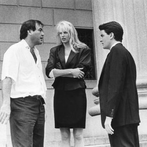 WALL STREET, from left: director Oliver Stone, Daryl Hannah, Charlie Sheen, on location, 1987. ©20th Century-Fox Film Corporation, TM & Copyright