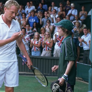 Peter Colt (PAUL BETTANY) and a ball boy (JONATHAN TIMMINS) wish each other luck mid-match in Working Title Films' romantic comedy Wimbledon. photo 14