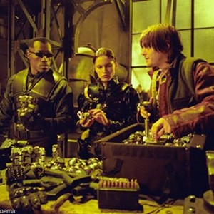 Blade (Wesley Snipes, left), Nyssa (Leonor Varela, center) and Scud (Norman Reedus) review their new weapons in New Line Cinema's action thriller, BLADE II.