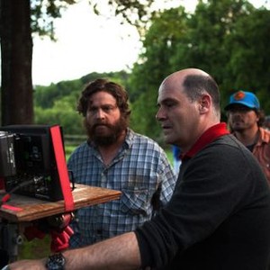 ARE YOU HERE, Zach Galifianakis (beard), director Matthew Weiner (front), on set, 2013. ph: James Bridges/©Millennium Entertainment