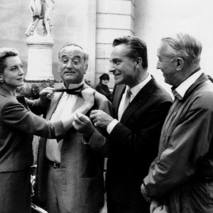 COUNT YOUR BLESSINGS, on location in Paris, Deborah Kerr, playfully strangling director Jean Negulesco, while Rossano Brazzi, Maurice Chevalier, look on, October 1958