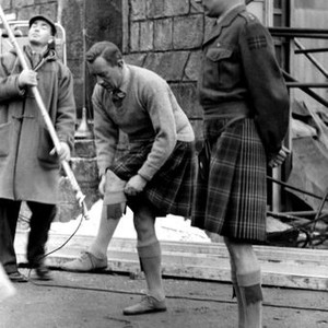 TUNES OF GLORY, Alec Guinness (center) adjusting his socks on set, 1960
