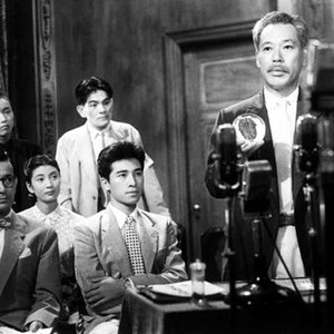 GODZILLA, (aka GOJIRA), Fuyuki Murakami (seated, glasses), Toyoaki Suzuki (boy, standing), Momoko Kochi (lace dress), Akira Takarada (seated, patterned tie), Takashi Shimura (at microphones), 1954