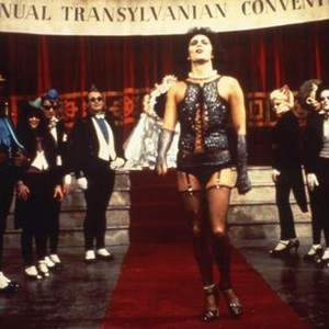 THE ROCKY HORROR PICTURE SHOW, Tim Curry (center), Nell Campbell (right, gold top hat), Patricia Quinn (maid's uniform), Richard O'Brien (bald, second from right), 1975. TM & Copyright ©20th Century Fox. All rights reserved.