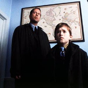 Bruce Willis (left) stars as child psychologist Dr. Malcolm Crowe, whose young patient, Cole Sear (Haley Joel Osment, right), is frightened by his visions of ghosts.