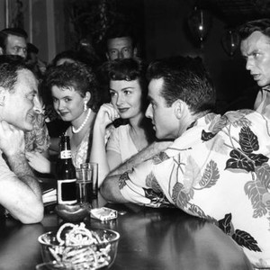 FROM HERE TO ETERNITY, director Fred Zinneman (left) directing Donna Reed (center, Montgomery Clift (sitting at bar), Frank Sinatra (back right), while extras look on, on set, 1953