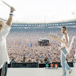 BOHEMIAN RHAPSODY, BACK TO CAMERA L-R: GWILYM LEE AS BRIAN MAY, BEN HARDY AS ROGER TAYLOR, JOE MAZZELLO AS JOHN DEACON, CENTER: RAMI MALEK AS FREDDIE MERCURY RECREATING QUEEN'S FAMOUS LIVE AID PERFORMANCE AT WEMBLEY STADIUM, 2018. TM & COPYRIGHT © TWENTIETH CENTURY FOX FILM CORP. ALL RIGHTS RESERVED.