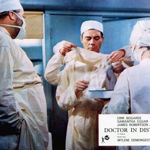 DOCTOR IN DISTRESS, James Robertson Justice (left), Dirk Bogarde (eyes closed), 1963