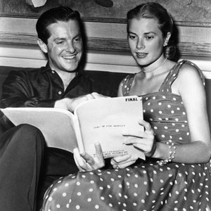 DIAL M FOR MURDER, from left: Robert Cummings, Grace Kelly reading the script on set, 1954