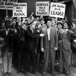 BLACK FURY, J. Caroll Naish (dark pinstripe suit, pointing), Vince Barnett (moustache, porkpie hat),  Paul Muni         (center, boe tie, bowler), 1935
