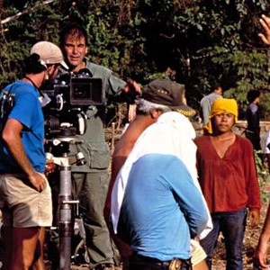 PLATOON, Oliver Stone, with the production crew, directing Charlie Sheen in a scene from the film, 1986.