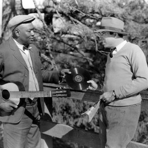 HALLELUJAH!, blues singer Jim Jackson handing one of his records to director King Vidor on set, 1929