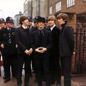 A HARD DAY'S NIGHT, The Beatles, Paul McCartney, Ringo Starr, John Lennon, George Harrison, 1964, candid on the set with the London policemen who would share the scene with them.