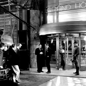 GRAND HOTEL, director Edmund Goulding (leaning on camera) filming Lionel Barrymore, John Barrymore, Joan Crawford on set, 1932